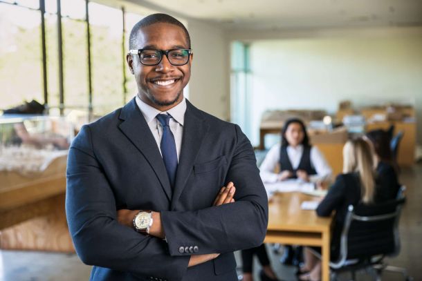 smiling owner ceo at office work place portrait of worker in suit glasses and tie looking handsome